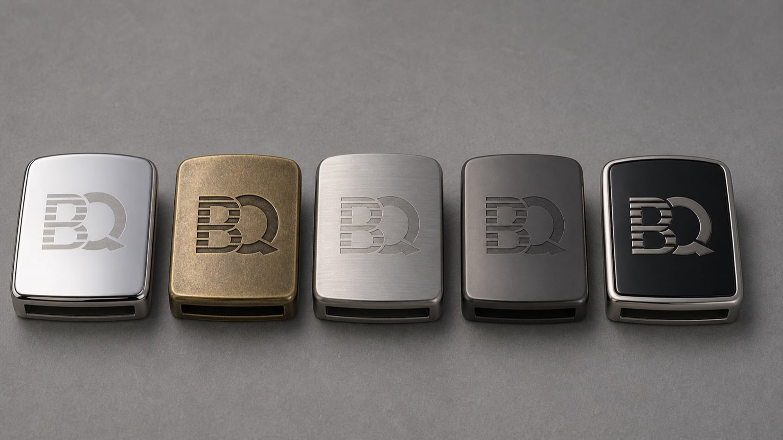 Belt buckle finish samples with BQ logo applied by laser etching, debossing, engraving, and raised metal detail